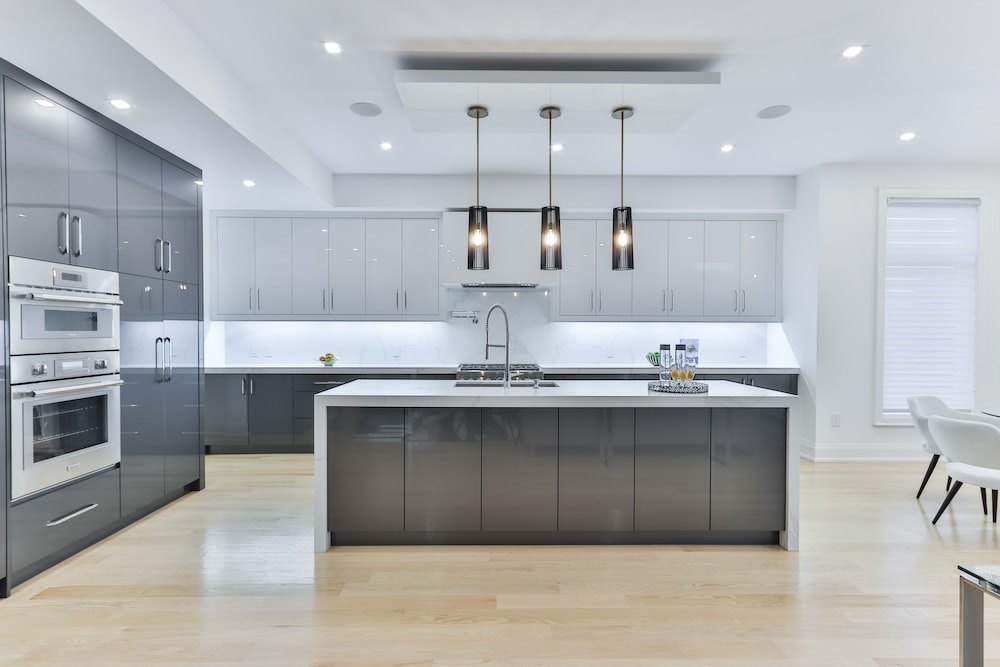  a modern kitchen with grey cabinets and stainless steel appliances