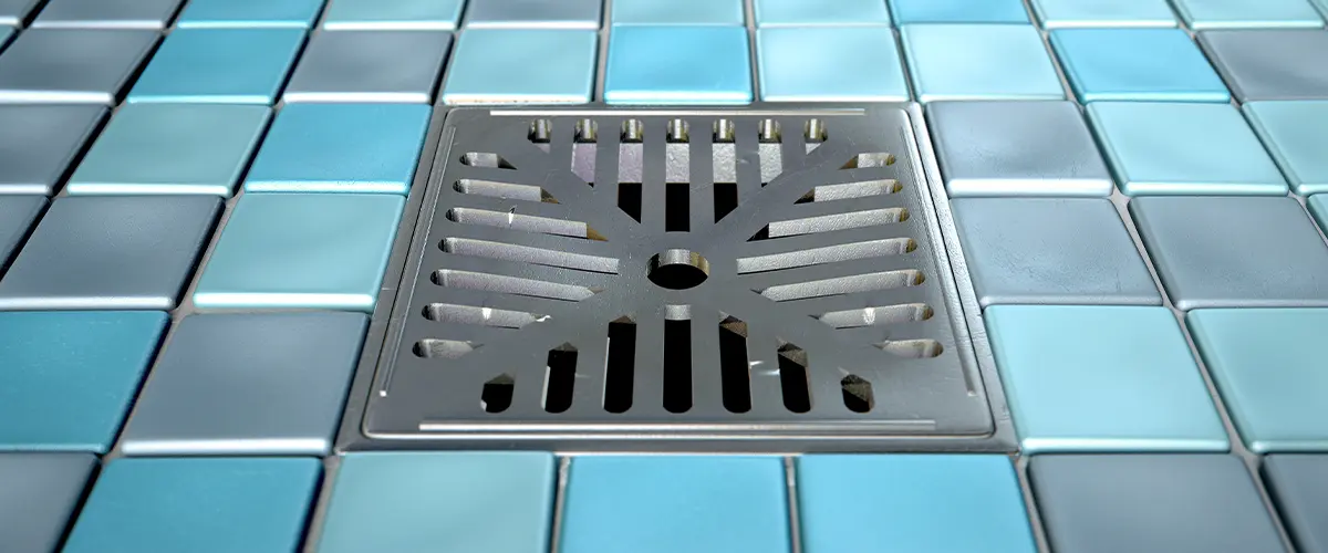 square shower drainage with blue tiling