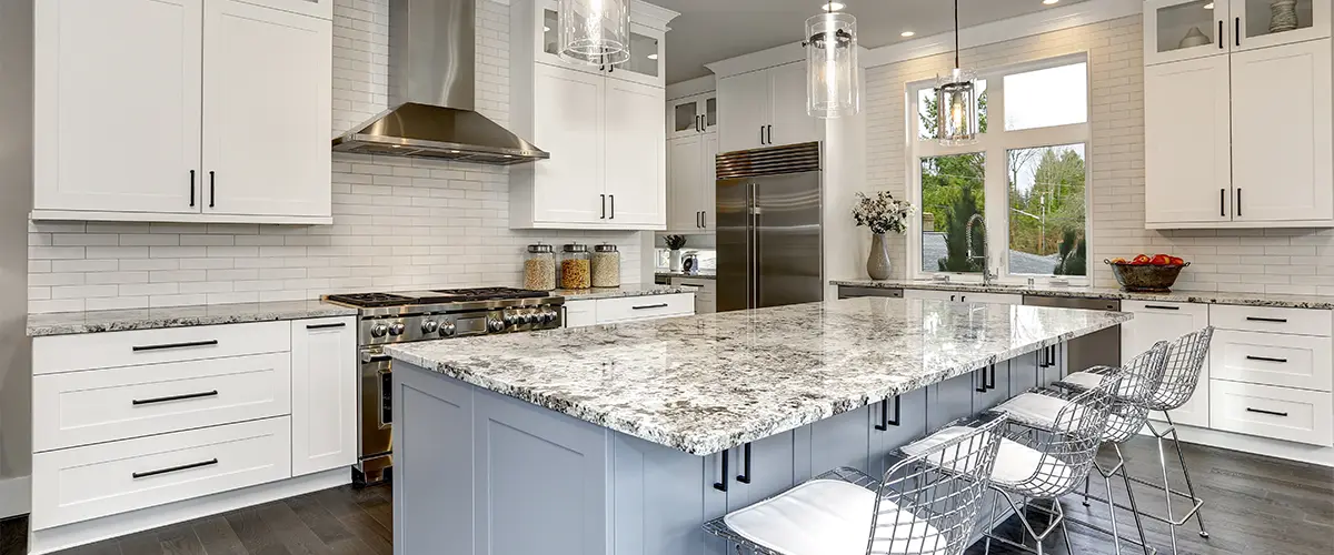 Beautiful kitchen in luxury home interior with island and stainless steel chairs