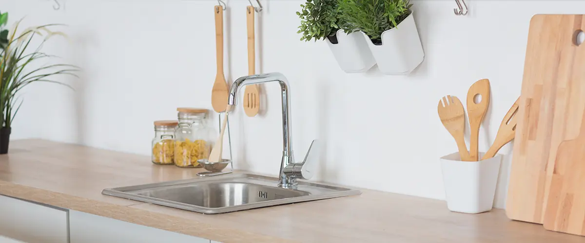 Single stainless sink on wood countertop