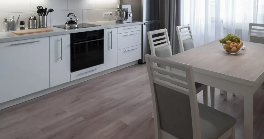 Traditional kitchen with tile flooring, wooden cabinets, stainless steel appliances, and a central island with bar seating.
