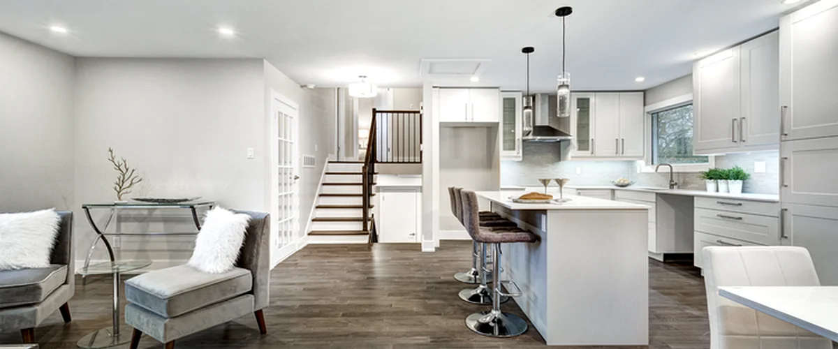 basement remodeling greenwood mo basement finishing modern open concept basement with white cabinetry island seating and hardwood flooring