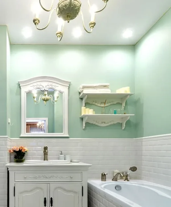 Luxury vintage bathroom with mint green walls and white vanity by bathroom remodeling companies in Raymore, MO.