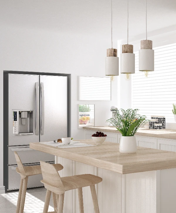 A bright, airy kitchen refresh in Pleasant Hill, MO showcasing a light wood island with matching wooden bar stools, a modern stainless steel refrigerator, and rustic wood-accented pendant lights.